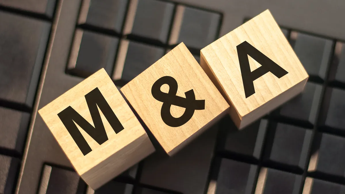 The letters 'M' and 'A' printed on two wood building blocks that are sitting on a computer keyboard.