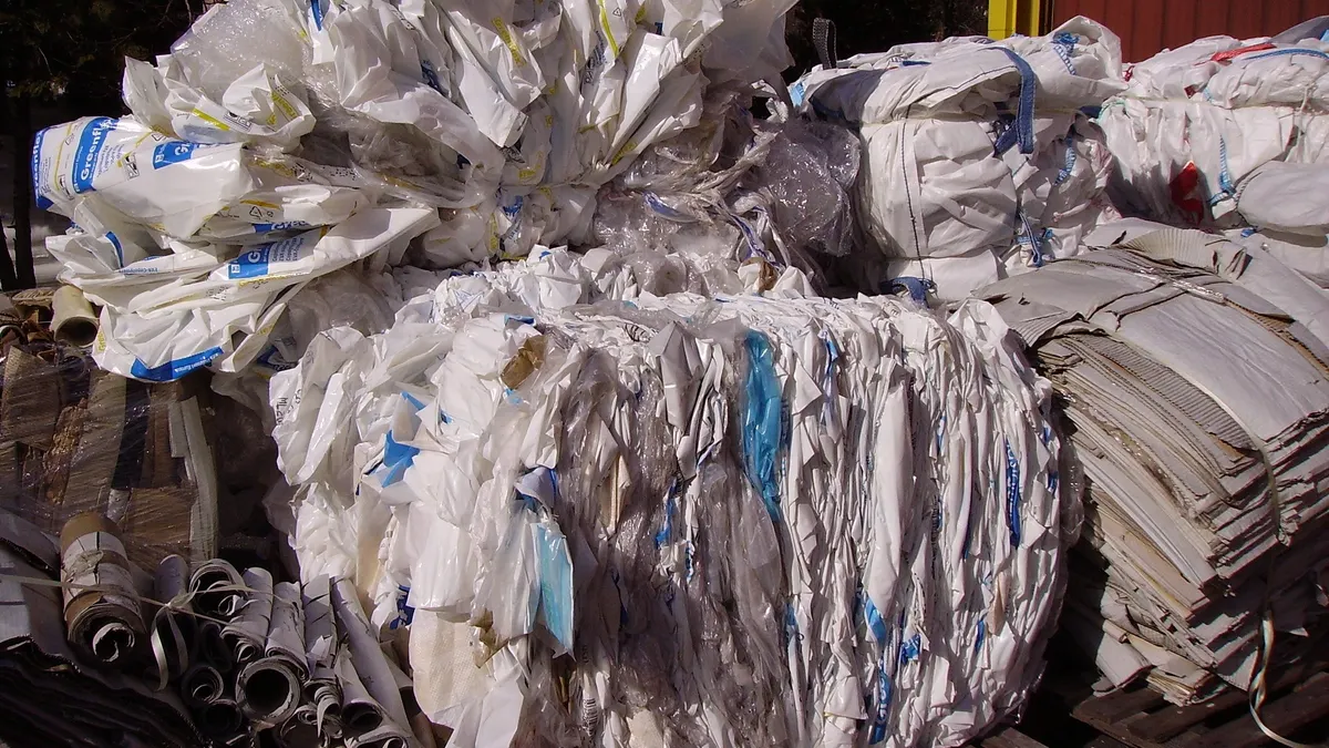 Industrial plastic packaging and pipes is stuffed into a container