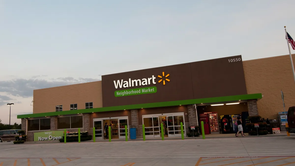 A store with a banner that says "Walmart" with a sunshine logo and "Neighborhood Market" in white letters against a green background.