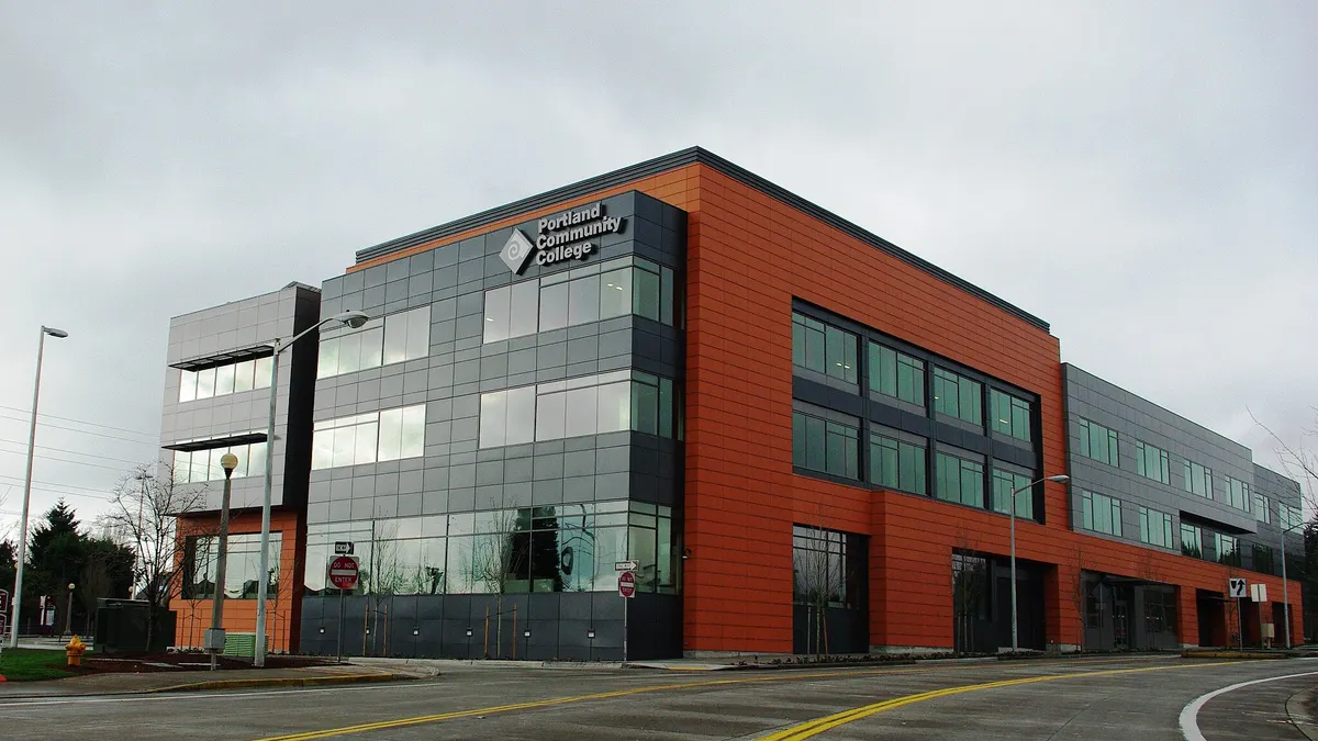 Orange and gray building with Portland Community College sign in corner.