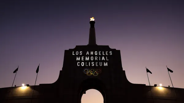A flame atop the Los Angeles Memorial Coliseum at night.