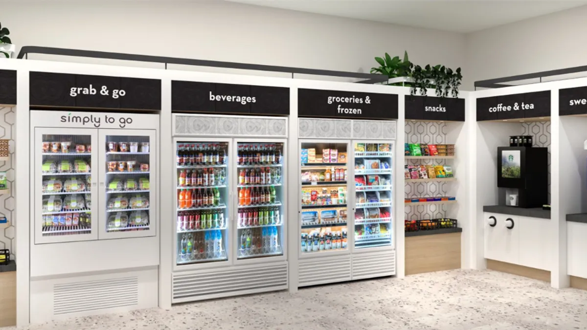 An image showing the inside of a convenience store with shelves and coolers along the walls. signs above various parts of the store read Snacks, Grab and Go, Beverages, Groceries and Frozen, Coffee and Tea and sweets and treats.