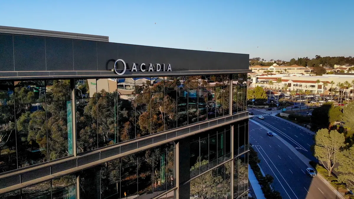 A sign for Acadia Pharmaceuticals is seen on the side of an office building.