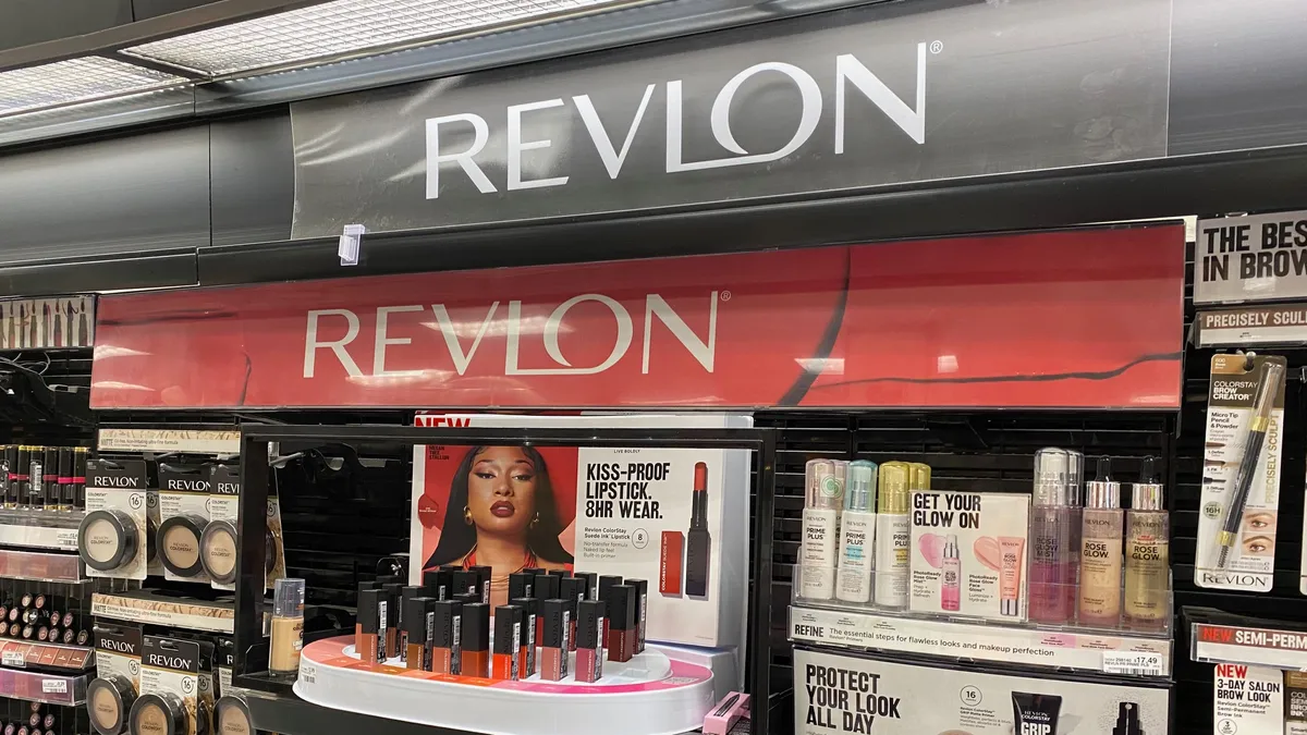 Line up of Revlon products inside of a store with the Revlon sign.