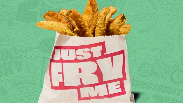 A photo of fried slices of fried jalapeno pepper in a paper envelope against a green background. Text on the envelope says Just fry me.