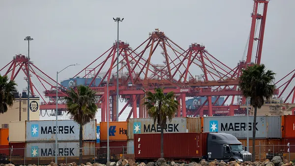 A truck drives by a port.