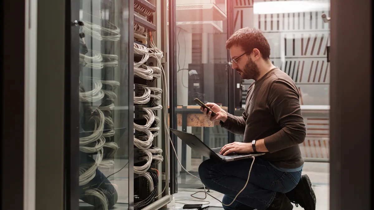 Engeneer at work in an IT server room.