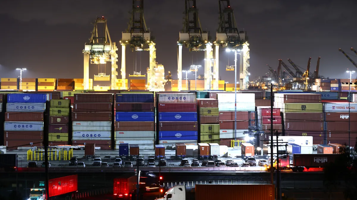 Trucks haul shipping containers at the Port of Los Angeles