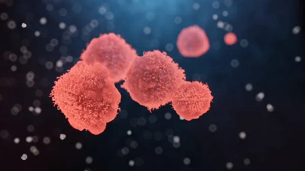 Illustration of cancer cells with textured surfaces against a dark blue background.