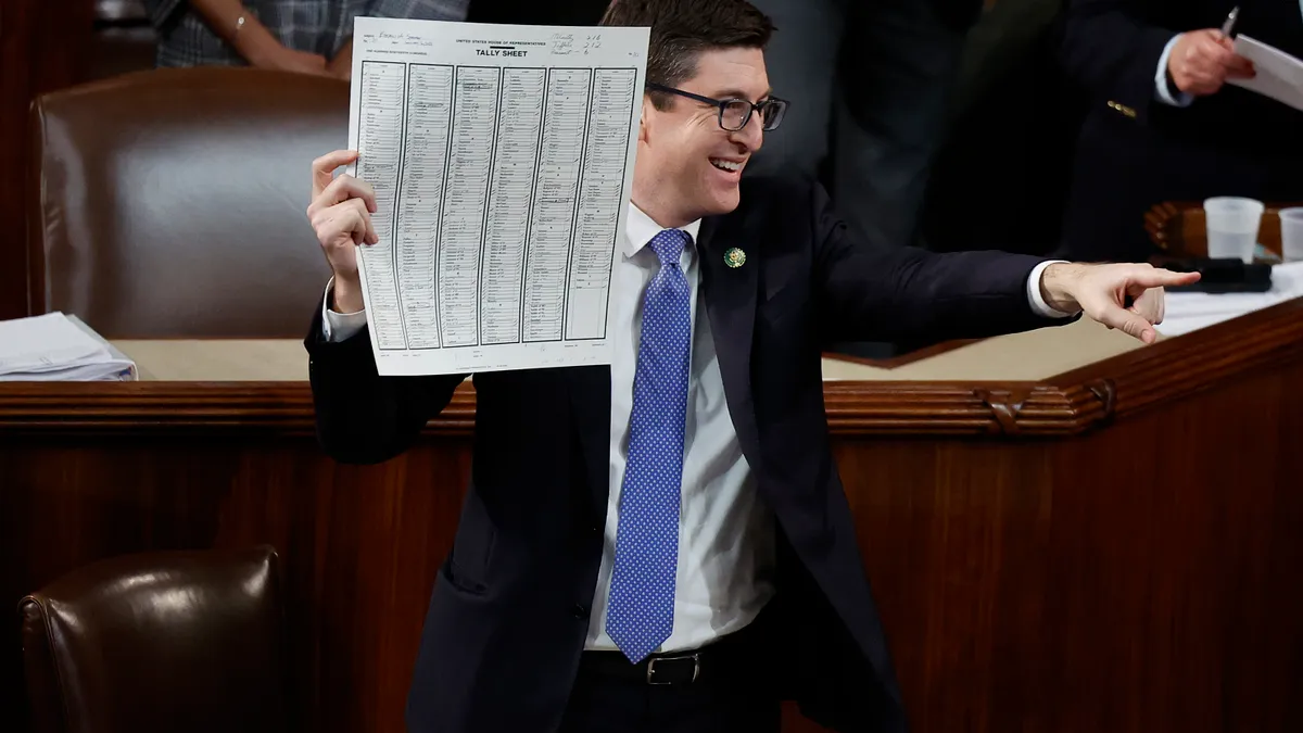 U.S. Rep.-elect Bryan Steil (R-WI) holds up a tally sheet as Republican Leader Kevin McCarthy (R-CA) is elected Speaker of the House