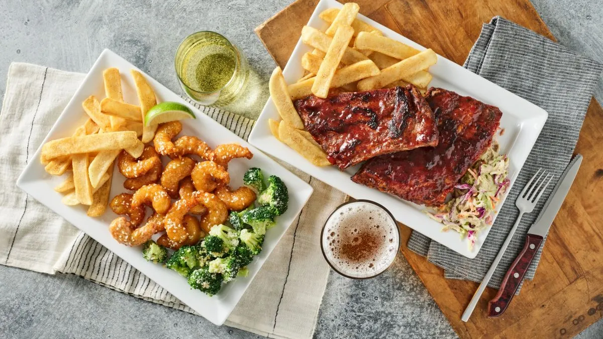 Red Robin menu items, including shrimp, fries and rigs atop white plates.