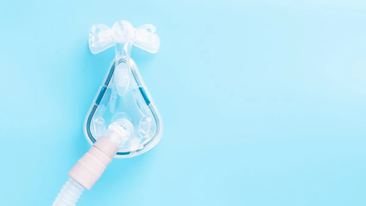 A CPAP mask on a blue background