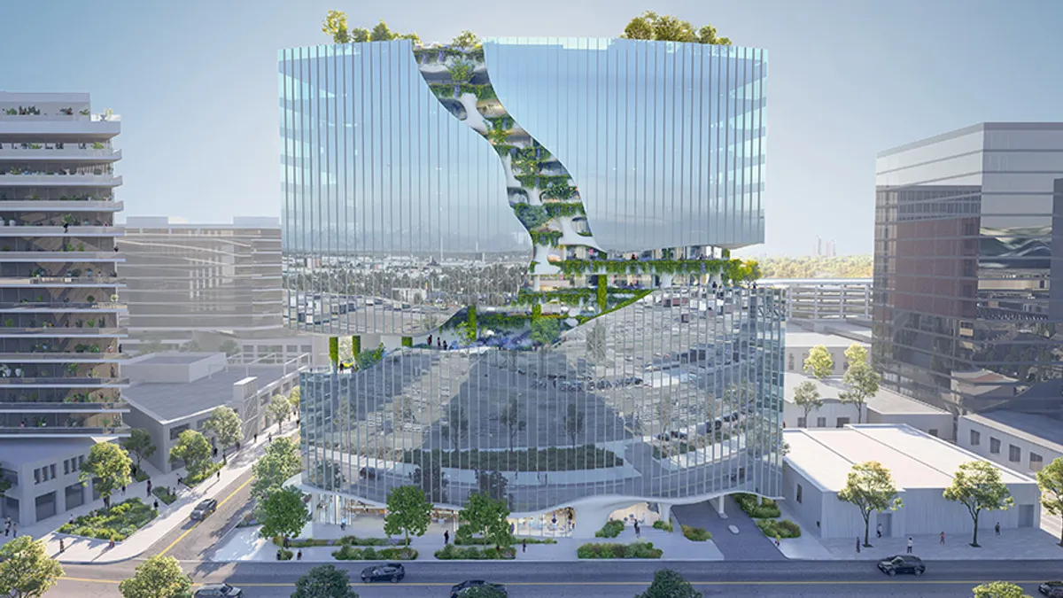 An apartment building with a mostly-glass facade, with a strip of greenery cutting through it.