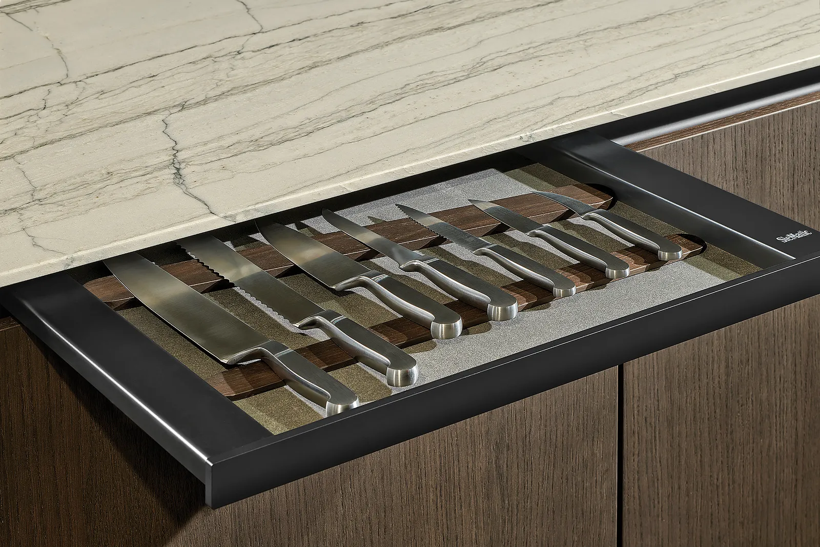 A long, thin drawer with a knife set inside.