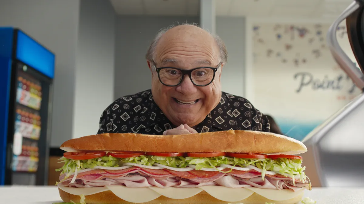 Actor Danny DeVito with a Jersey Mike's Subs sandwich