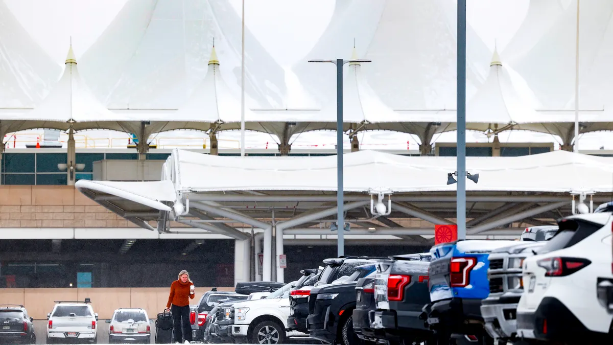 A woman walks to her car