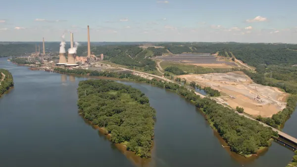 A power plant sits on a bend in a river.