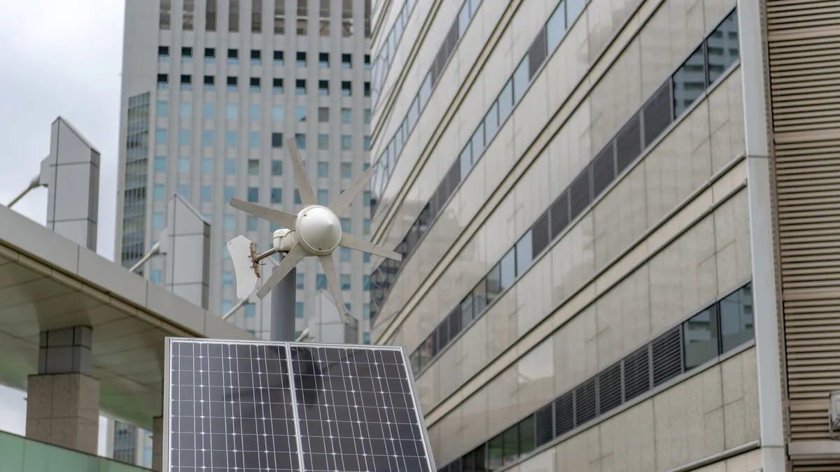 A view of tall buildings with a solar panel outside.