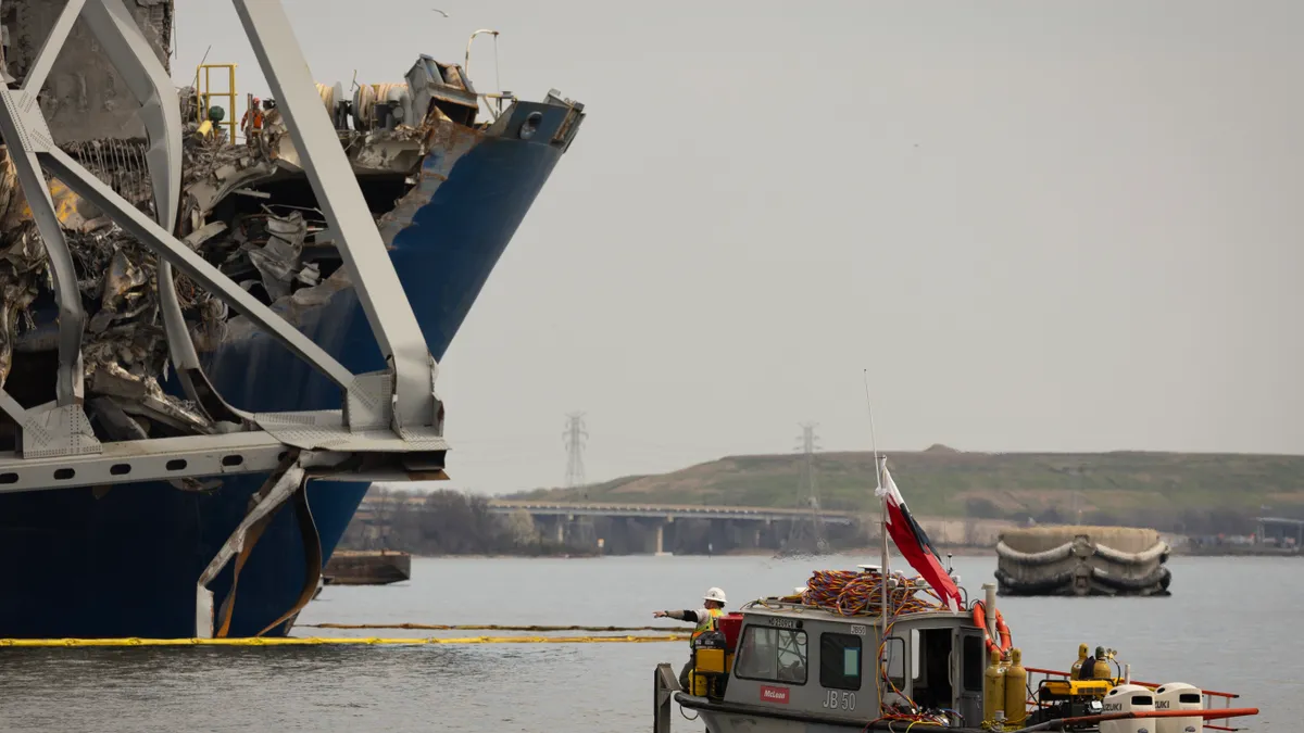 Debris is cleared from the collapsed Francis Scott Key Bridge.