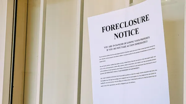 Foreclosure notice posted to a door.