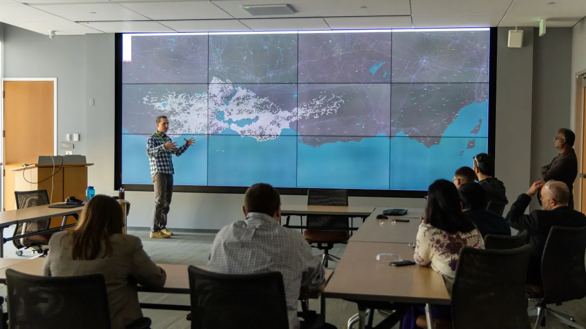 Workshop attendees view a large map of electricity infrastructure.