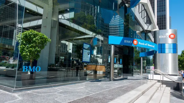 Exterior view of the BMO Bank of Montreal office building in downtown Vancouver, British Columbia, featuring modern glass architecture and the BMO logo prominently displayed.