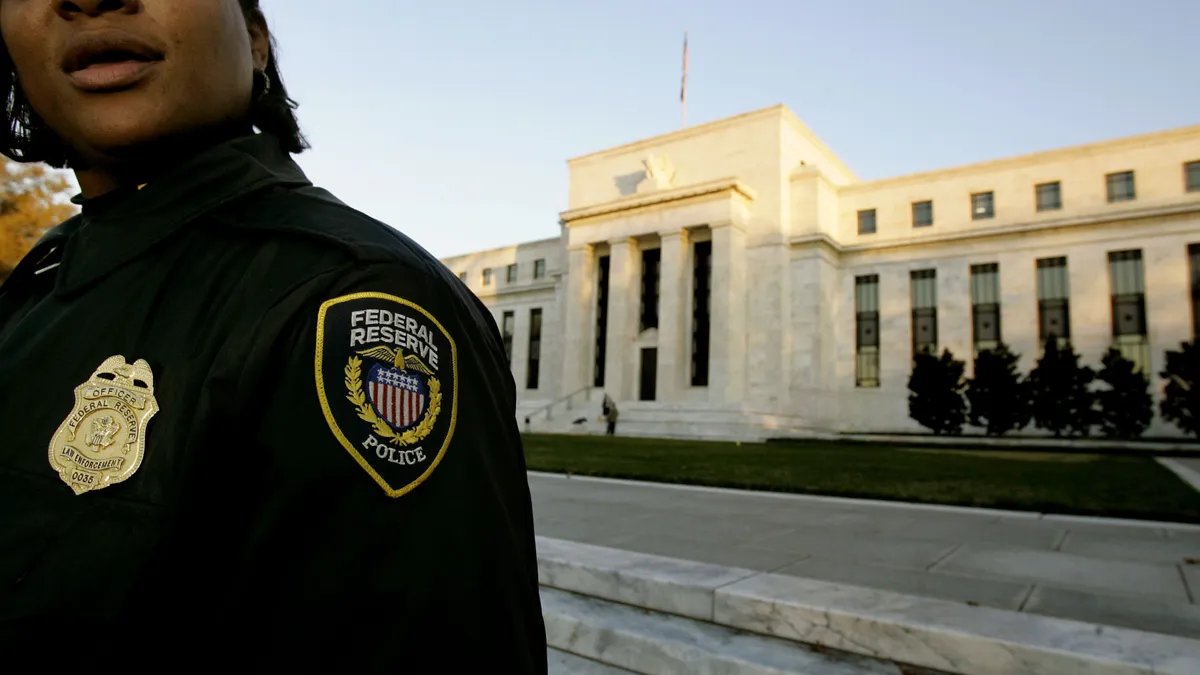 police officer stands in front of federal reserve bank