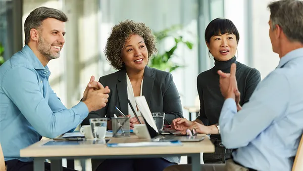 People smiling in a meeting