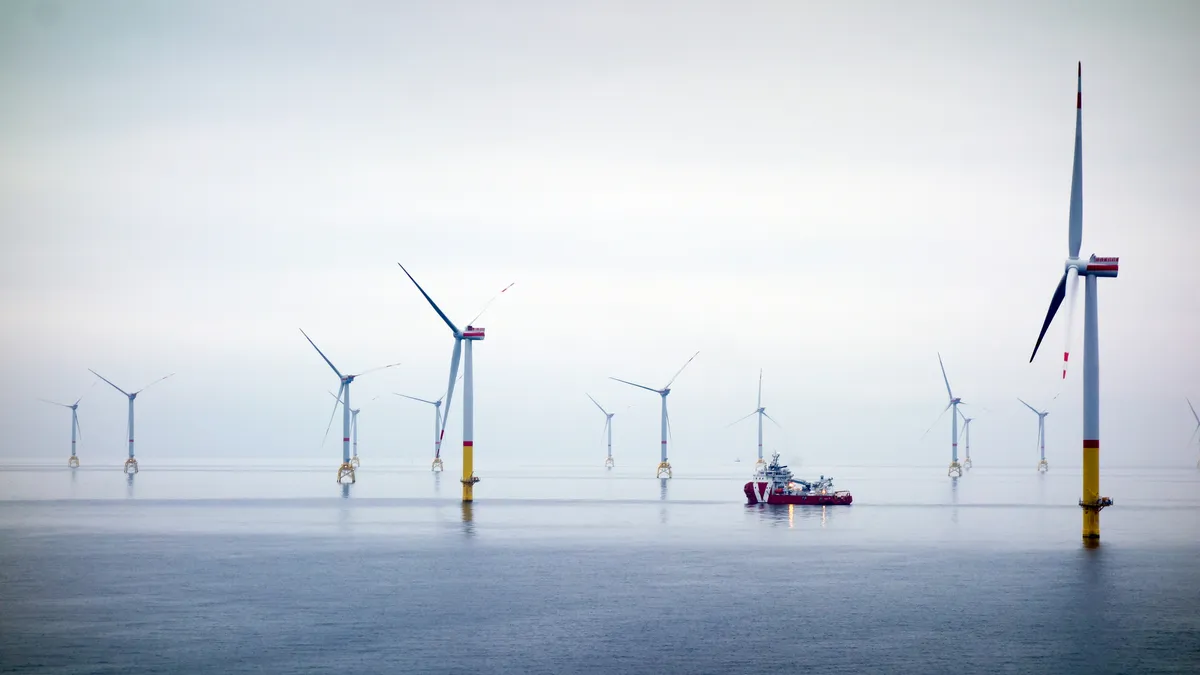 Floating wind turbines off the coast of the ocean on a cloudy day.