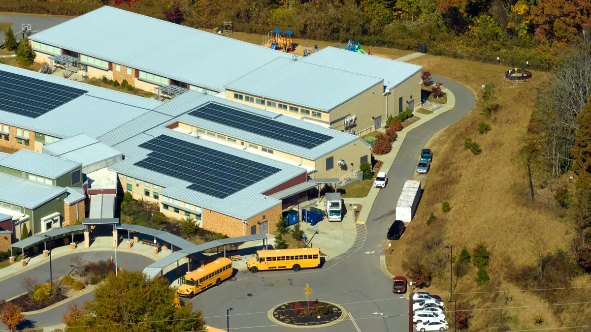 Roof of american school building covered with photovoltaic solar panels for production of electric energy.