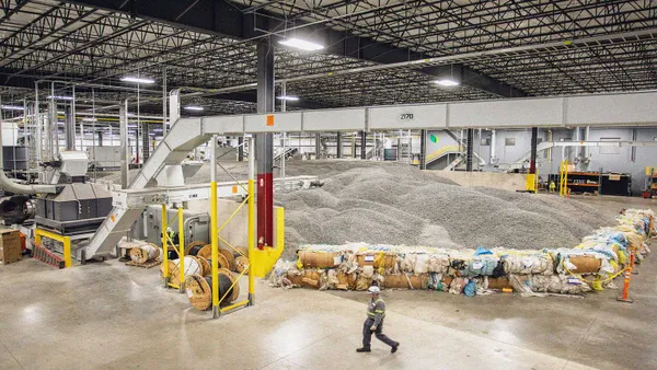 A worker walks through an industrial facility