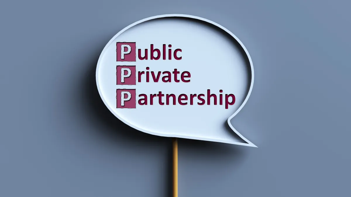 Quote mark sign on a stick that says "public private partnership"