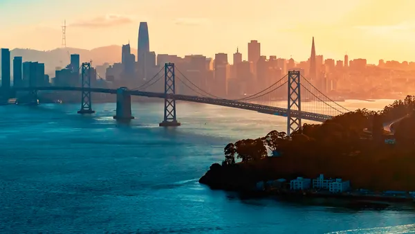 Aerial view of the Bay Bridge in San Francisco, California with skyline in background