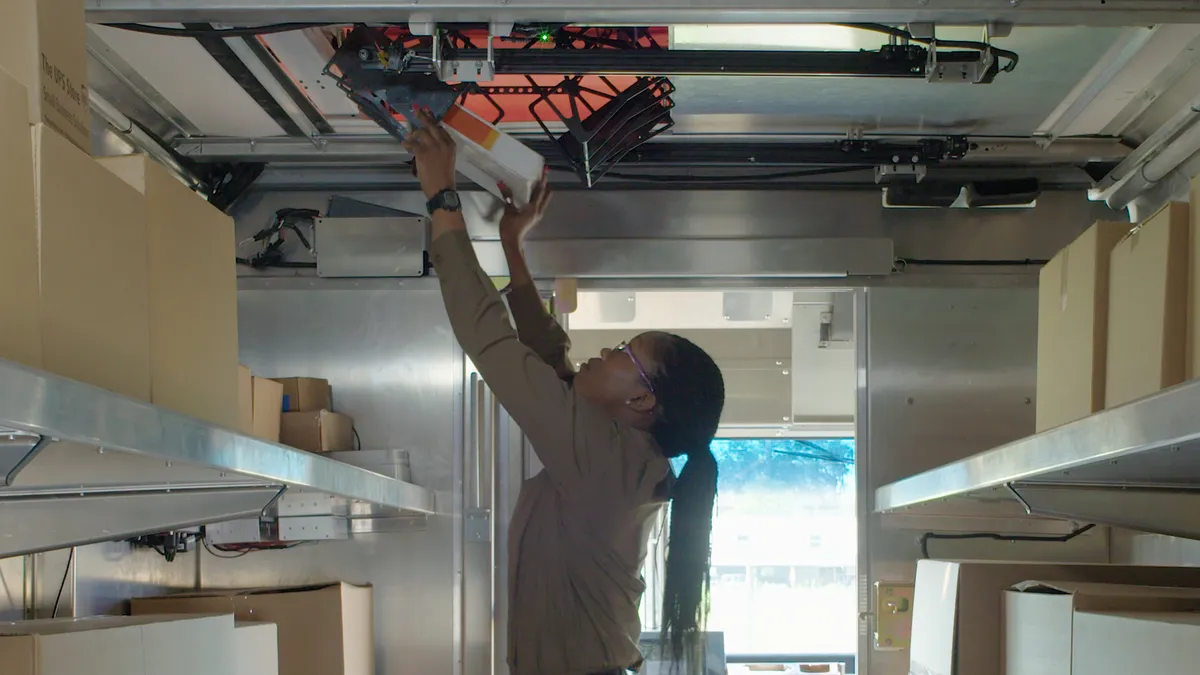 UPS employee loading a drone