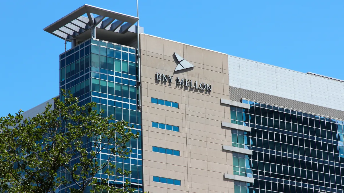 A building bearing BNY Mellon logo against a clear blue sky