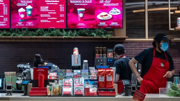 Baristas work in a Starbucks coffee shop in Manhattan on December 02, 2025 in New York City.