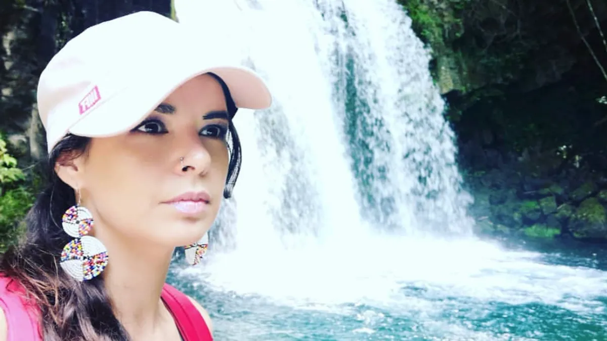 Woman by waterfall