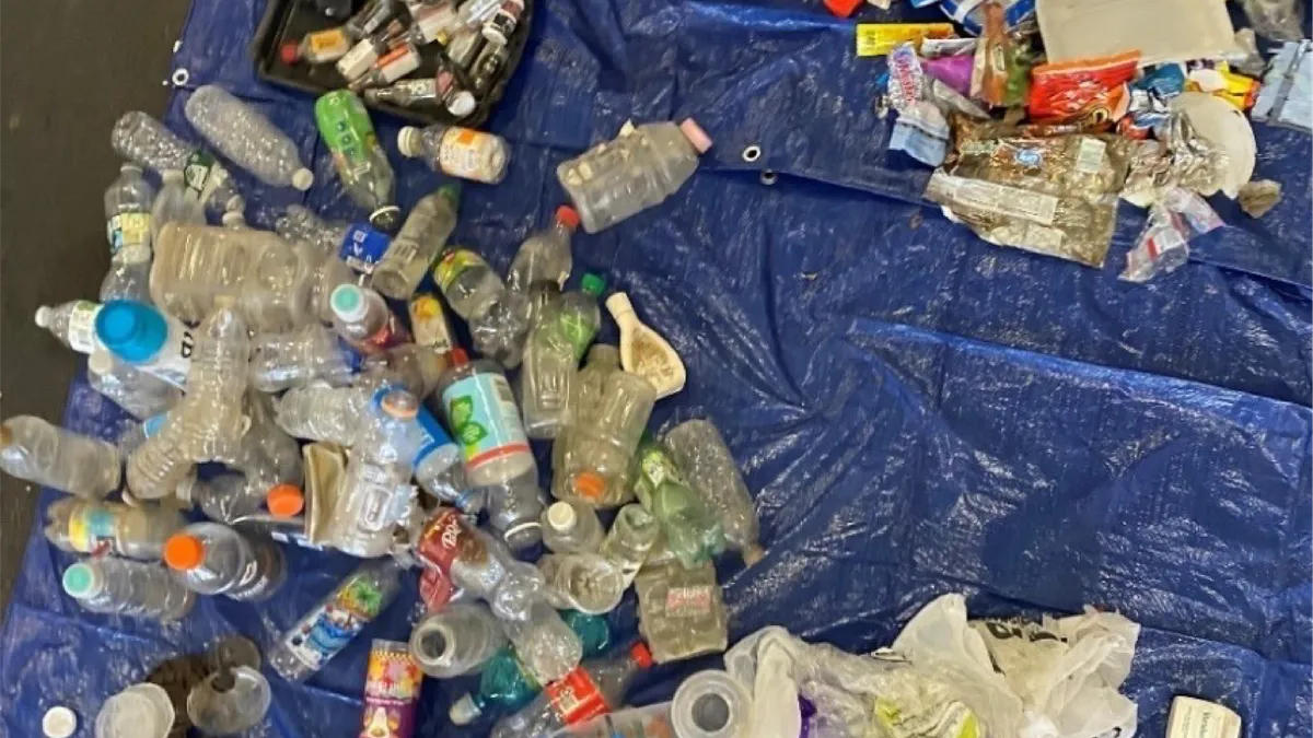 Plastic waste floating in water,  including Gatorade bottles and Lay’s potato chip packaging, that was collected in April 2022 from the Erie Basin Marina in Buffalo, New York.