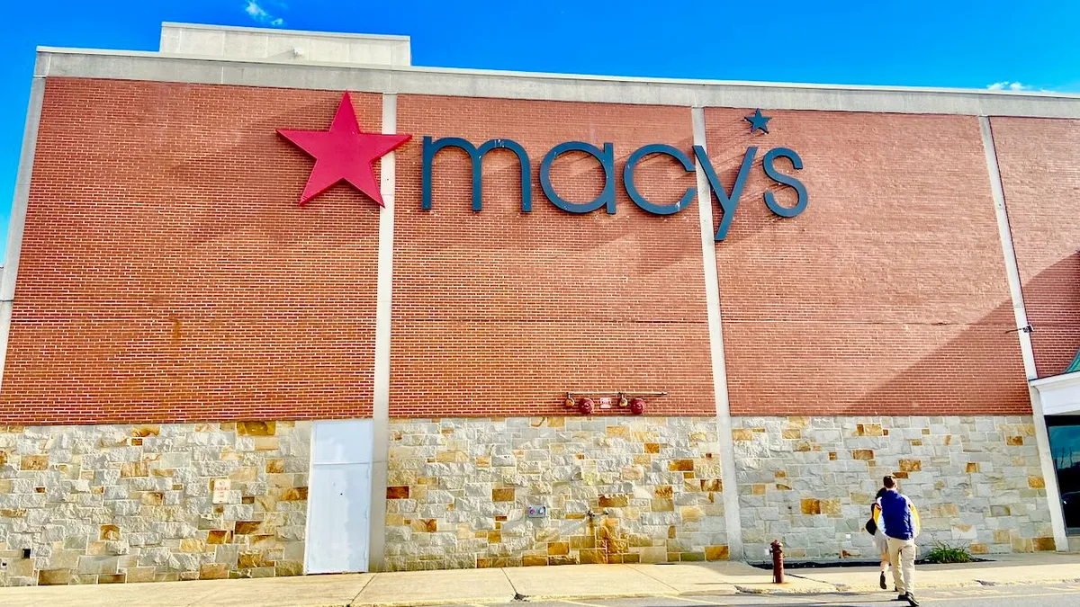 People walking toward a Macy's store.