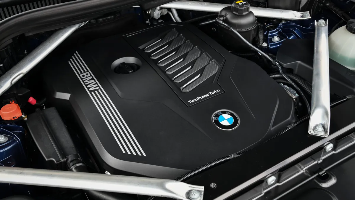 The engine bay of a 2019 BMW X5 xDrive 40i SUV with the BMW logo on the cover.