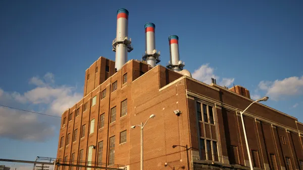 A factory with three smoke stacks