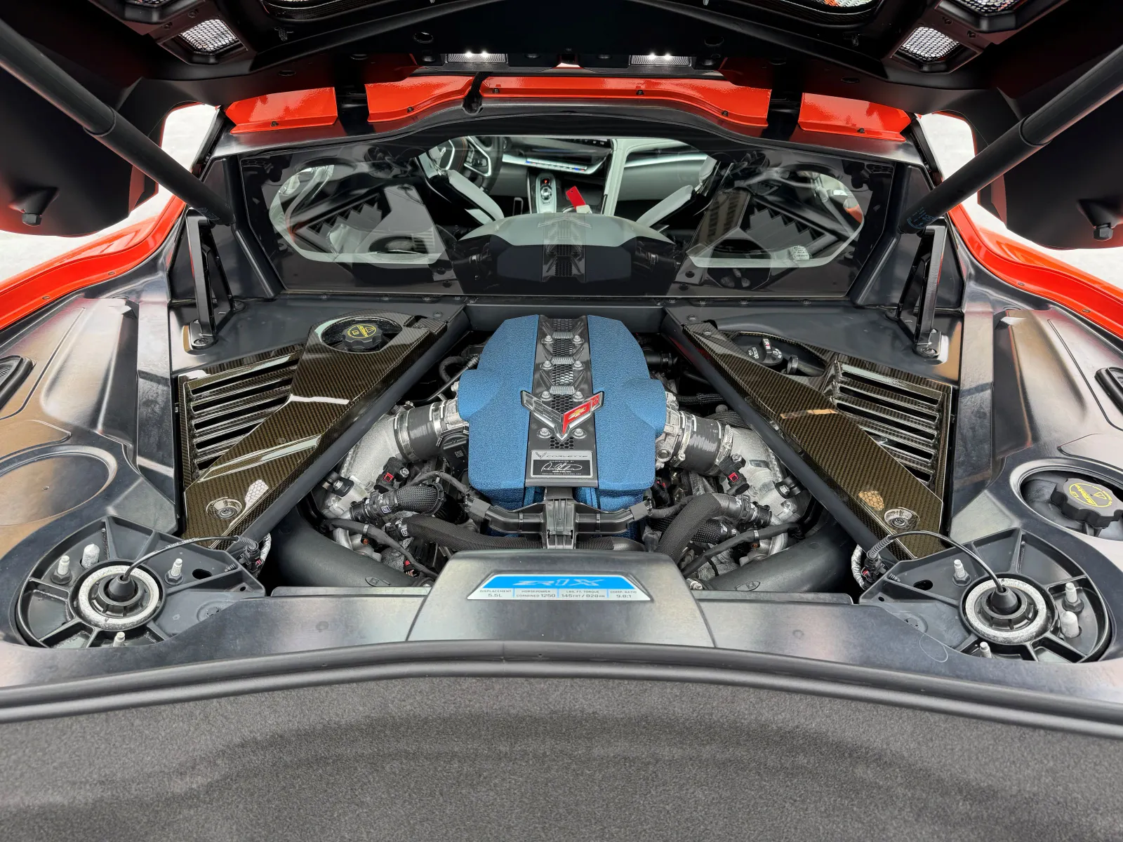 Under the hood of a Chevrolet Corvette, the hybrid engine is visible.