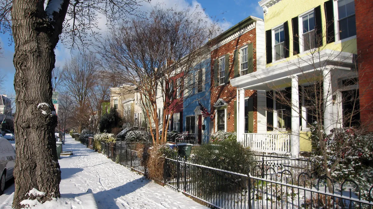 Sun shines brightly after a snow storm on a neighborhood street in Southeast, Washington, DC.