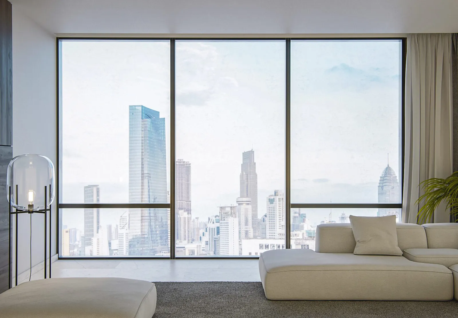 A living room with a window overlooking a city.