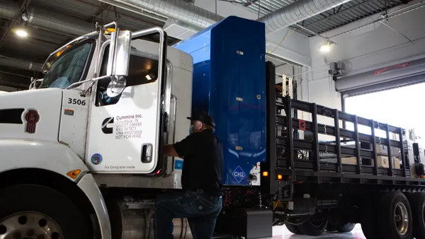 A hydrogen truck and driver prepare to leave a Cummins plant