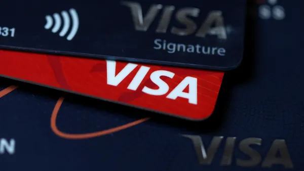 A close up view of a stack of visa bank cards.