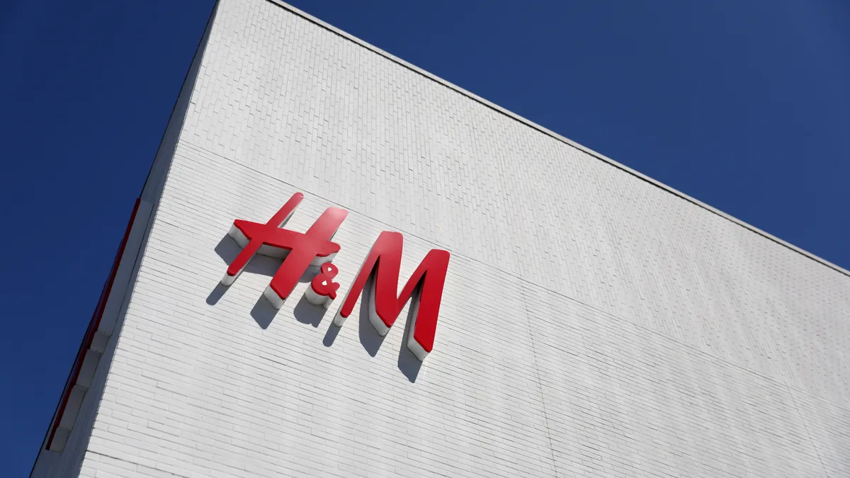 H&M's logo is pictured on a sign on a building.