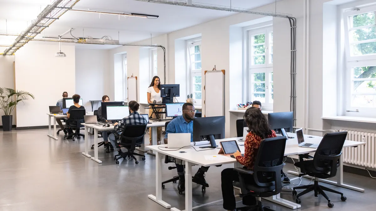 Diverse business people work in a modern open plan office.