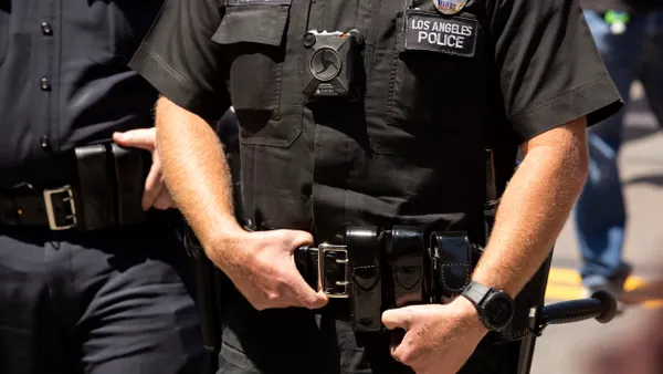 Torso of a person wearing Los Angeles Police Department uniform with a body camera.