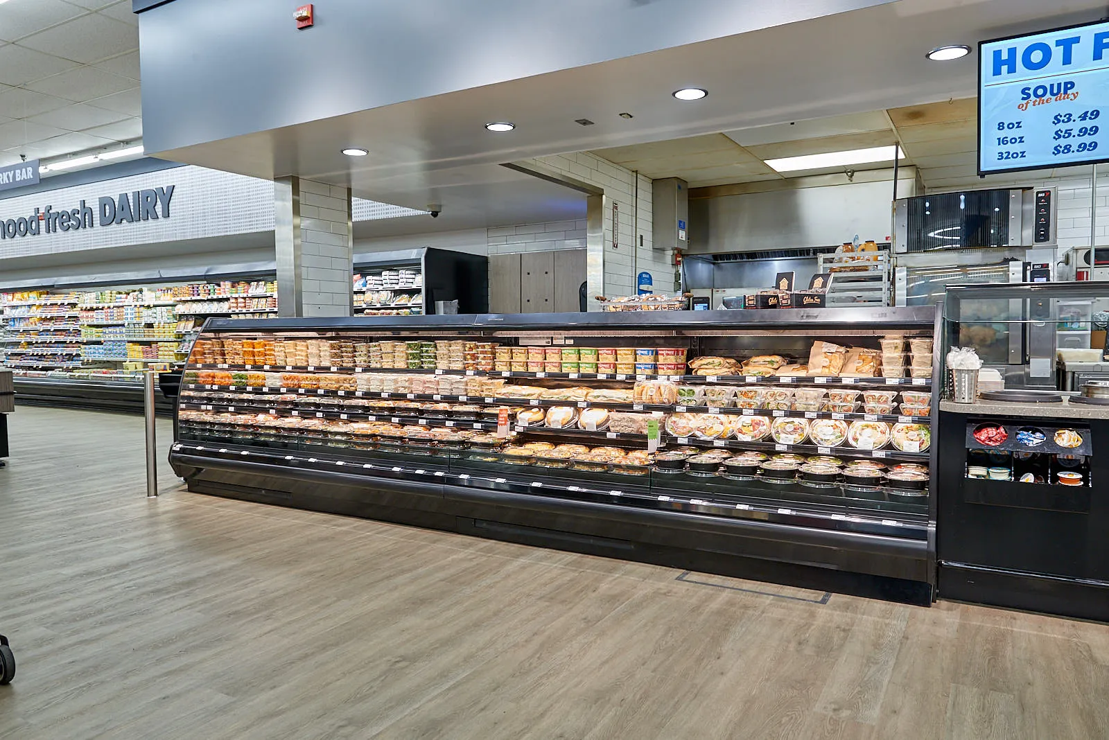 Prepared foods display in front of grocery store deli counter